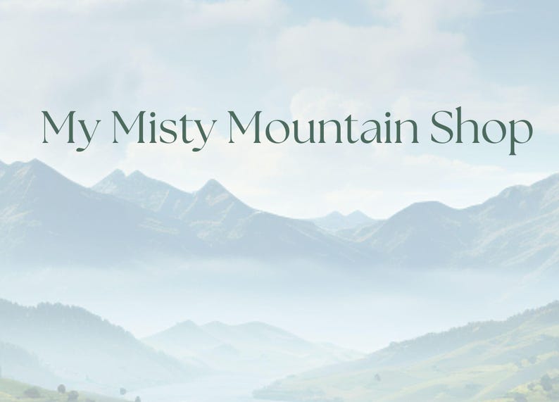 May include: The image features a serene mountain landscape with a misty atmosphere. The text "My Misty Mountain Shop" is displayed in elegant, dark green lettering against the backdrop of the mountains and sky.