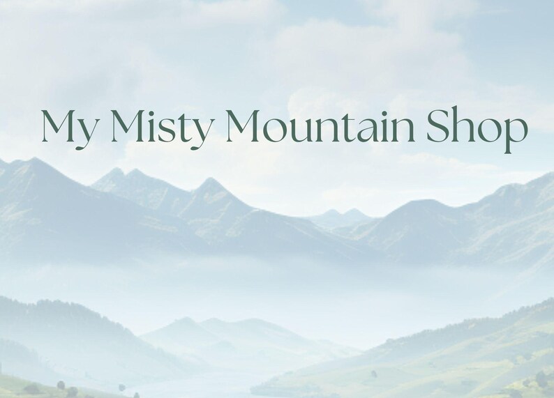 May include: A scenic landscape featuring a mountain range shrouded in mist under a cloudy sky. The text "My Misty Mountain Shop" is displayed in elegant, dark green lettering, suggesting a nature-themed business or product.