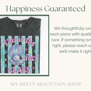 May include: A charcoal gray t-shirt featuring a graphic of an open seashell with a pearl. The text reads This is the -fect CLASS in pink bubble letters. The background of the graphic has vertical teal stripes and small colorful stars.