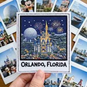May include: Embroidered patch featuring a nighttime scene with a castle, fireworks, and a large sphere, with the text "ORLANDO, FLORIDA." Surrounded by several small photographs of various Orlando attractions, including Mickey Mouse and a boat on the water.
