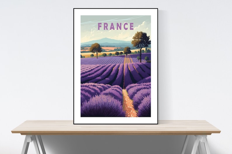May include: A vintage travel poster featuring a lavender field in France. The poster has a blue sky with white clouds and a mountain range in the background. The text "FRANCE" is printed in purple at the top of the poster.