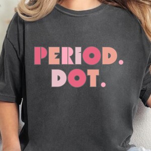 May include: A black oversized t-shirt with the text "PERIOD. DOT." in pink and red letters.