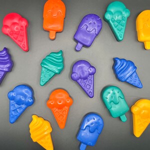 May include: Assortment of colorful ice cream cone and popsicle shapes made of wax. The shapes are in various colors, including blue, green, orange, red, and yellow.