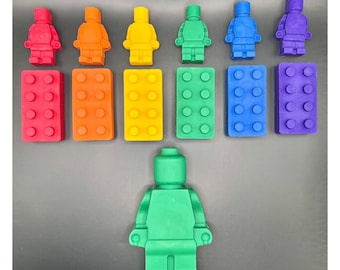 May include: A set of seven colorful Lego minifigures and their corresponding base plates. The minifigures are arranged in a rainbow pattern, with red, orange, yellow, green, blue, indigo, and violet. The base plates are the same colors as the minifigures.