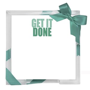 May include: A square clear acrylic memo holder featuring the text GET IT DONE printed in a sage green font. The holder is decorated with a sage green satin ribbon tied in a bow at the top right corner and wrapped around the bottom left corner.