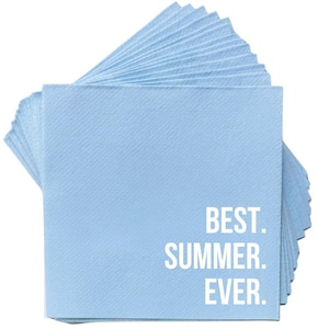 May include: A stack of square, light blue paper napkins featuring the white printed text BEST. SUMMER. EVER. in a clean, sans-serif font. The napkins are layered in a fan-like arrangement, showing the textured surface of the paper material.