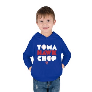 May include: A royal blue hooded sweatshirt with the words "Tomahawk Chop" in white letters with red accents and baseball graphics.