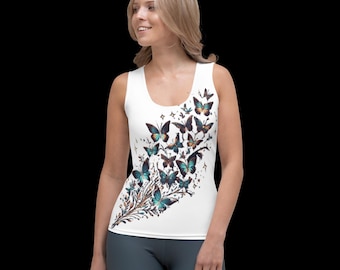 May include: White tank top featuring a colourful butterfly design. The butterflies are in shades of blue, green, and brown. The design is on the right side of the tank top.