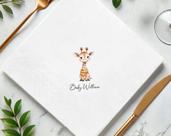 May include: White square paper napkin with a watercolor illustration of a baby giraffe. The giraffe has brown spots and a yellow bib. The text "Baby William" is printed below the giraffe. Gold cutlery and greenery are in the background.