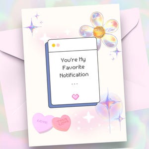 May include: A greeting card with a light pink envelope. The card features a digital illustration with the text "You're My Favorite Notification" inside a window. Two heart-shaped candies read "LOVE" and "TRUE LOVE". Decorative stars and a flower are also present.