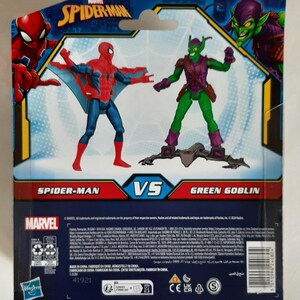 May include: Marvel Spider-Man vs. Green Goblin action figure set. The packaging features Spider-Man in a red and blue suit with web wings, facing off against the Green Goblin in a green and purple costume. The Marvel logo is visible.
