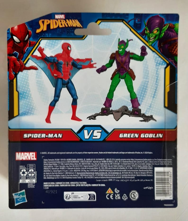 May include: Marvel Spider-Man vs. Green Goblin action figure set. The packaging features Spider-Man in a red and blue suit with web wings, facing off against the Green Goblin in a green and purple costume. The Marvel logo is visible.