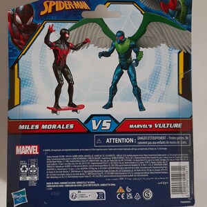 May include: Marvel Spider-Man action figure set featuring Miles Morales on a skateboard and Marvel's Vulture. The figures are on a blue and red background with the Marvel logo and the text "Miles Morales VS Marvel's Vulture".