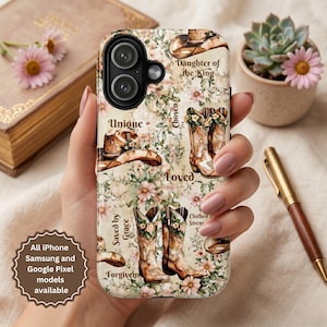 May include: A beige phone case featuring a floral and cowboy boot design with the words "Unique", "Chosen", "Loved", "Saved by Grace", "Forgiven", "Daughter of the King", and "Clothed in Strength". The case is available for iPhone, Samsung, and Google Pixel models.