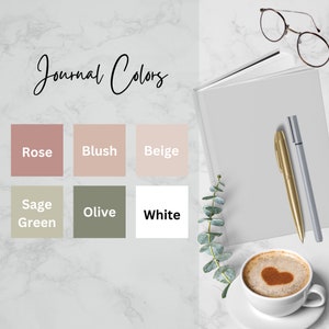 May include: Journal Colors: Rose, Blush, Beige, Sage Green, Olive, White. A white notebook with two pens, a cup of coffee with a heart design in the foam, and a sprig of greenery.