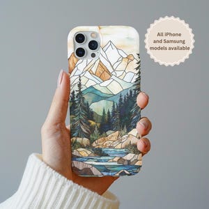 May include: A phone case with a stained glass design of mountains, trees, and a river. The text "Faith can move mountains" is written on the bottom of the case.