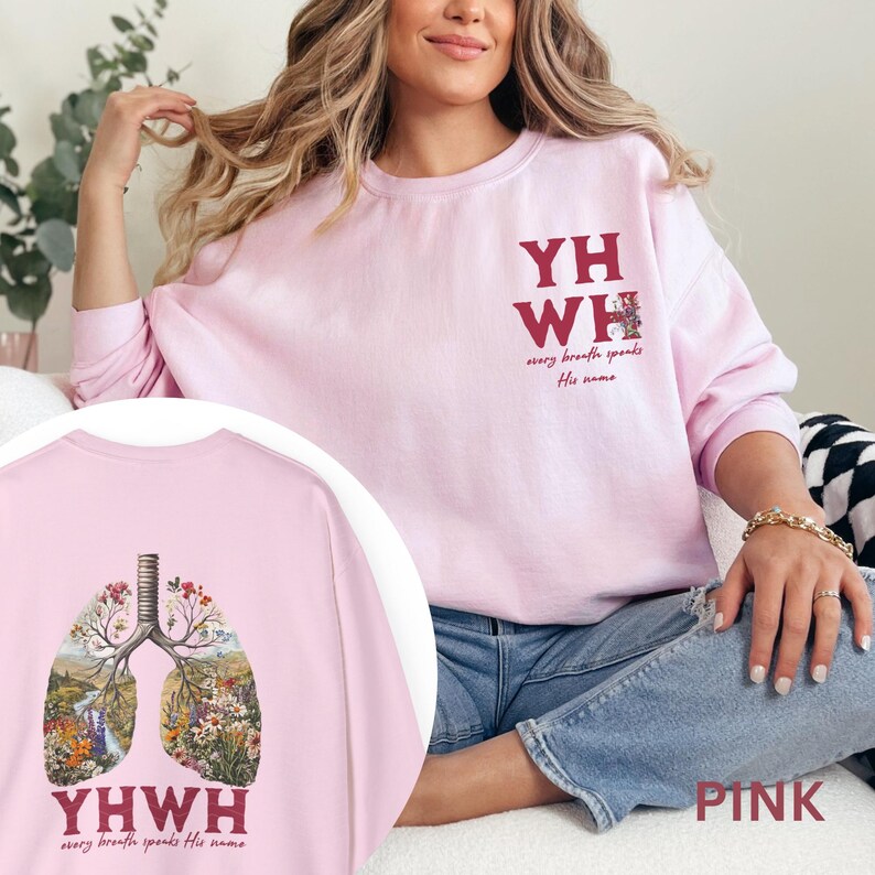 May include: Pink sweatshirt with a floral design of lungs and the text "YHWY every breath speaks His name" on the front. The back of the sweatshirt has the text "YHWH every breath speaks His name" in a maroon color.