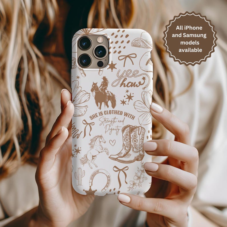 May include: White iPhone case with a brown and white design featuring a cowboy boot, a horse, a cactus, a horseshoe, and the text "She is clothed with strength and dignity" and "Yee Haw".