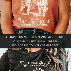 May include: A dark gray and a rust colored t-shirt with a graphic of a woman on horseback. The text on the shirt reads "Following Jesus isn't an easy road, but it's the only road worth following".