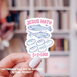 May include: A die-cut sticker featuring the pink text JESUS MATH at the top and 5+2=5000 at the bottom. The center displays two blue line-art fish and five blue line-art loaves of bread, all set against a white background with a thin border.