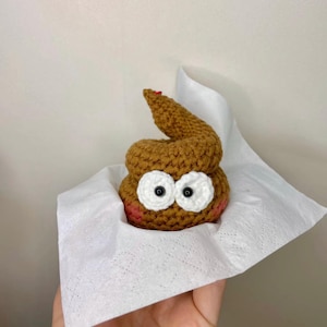 May include: A white ceramic mug with a black handle and the text "But First, Coffee" in a handwritten style. The mug is on a white surface. The mug is 4 inches tall.