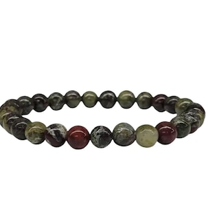 May include: A bracelet made of natural stone beads in shades of dark green, burgundy, and cream. The beads have varied textures and patterns. The bracelet is strung on an elastic cord. The beads are approximately 0.8 cm in diameter.