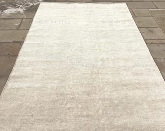 Alfombra de lana anudada a mano: color crema marfil, textura lisa minimalista