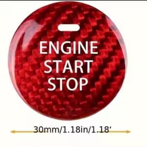 May include: A red, circular engine start/stop button with a carbon fiber texture. The button has white text that reads "ENGINE START STOP". The diameter is 1.18 inches.