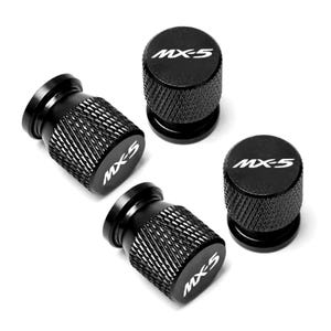 May include: Set of four black metal valve stem caps with the text "MX-5" in white lettering.
