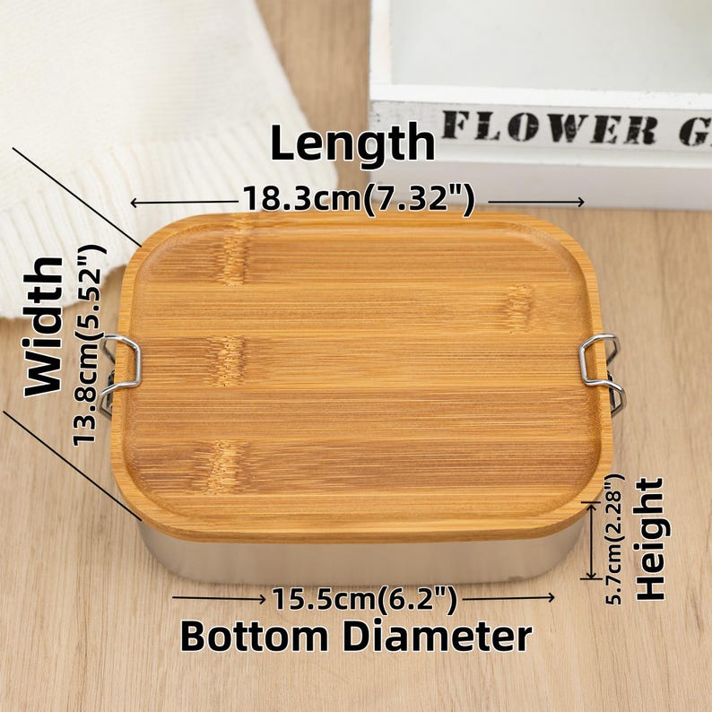 May include: A rectangular bamboo lunch box with a stainless steel rim and two metal clasps. The lunch box measures 7.32 inches long, 5.52 inches wide, and 2.28 inches high. The bottom diameter is 6.2 inches.