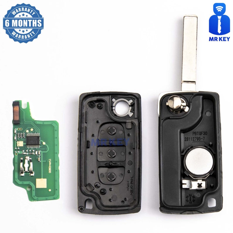 May include: A black car key with a silver key blade. The key has three buttons and a small circuit board. The key is open and the circuit board is visible. The key has the text "PBTGF30 28112795-7" printed on it.