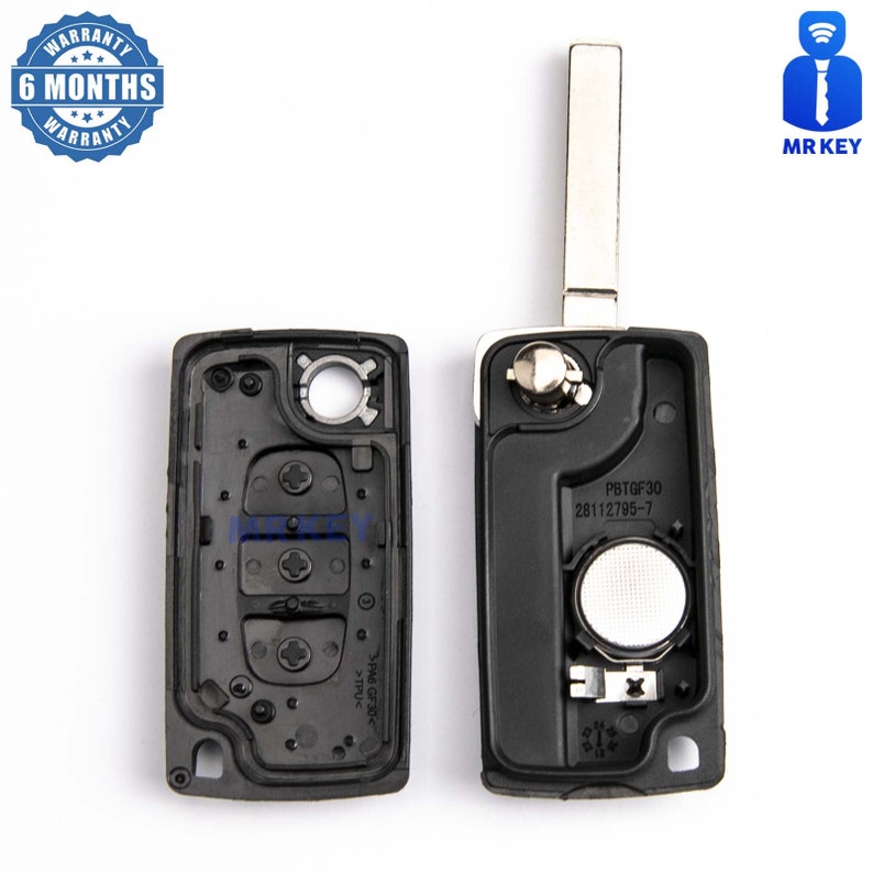 May include: A black car key fob with a silver key blade. The fob has four buttons and a battery compartment. The text "PBTGF30 28112795-7" is printed on the fob.