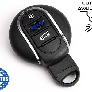 Peut inclure: Télécommande de voiture noire avec garniture argentée et trois boutons. La clé porte le texte "MR KEY" et une icône de voiture. L'image comprend également le texte "CUTTING AVAILABLE" et un badge de garantie de 6 mois.