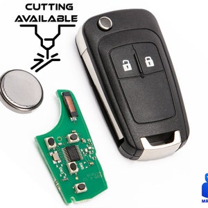 Puede incluir: Una llave de coche negra con dos botones, una placa de circuito verde y una batería plateada. La llave tiene un borde plateado. El texto "CUTTING AVAILABLE" es visible en la esquina superior izquierda de la imagen.