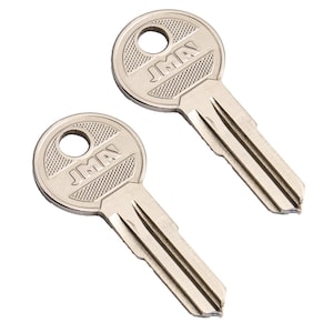 May include: Two silver keys with the text "JMA" on the head. The keys have a circular head with a hole and a textured pattern. The key blades are cut with grooves.