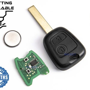 May include: A black car key with two buttons, one for locking and one for unlocking. The key has a gold-colored metal blade and a green circuit board. The key is accompanied by a small round battery and a 6-month warranty sticker.
