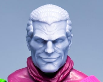 May include: A green and purple action figure with a white head and a pink strap across the chest.