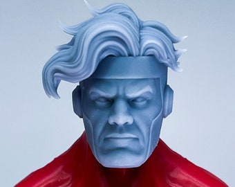 May include: A grey plastic action figure head with a sculpted hairstyle and a headband. The head has a serious expression with furrowed brows and a determined look.