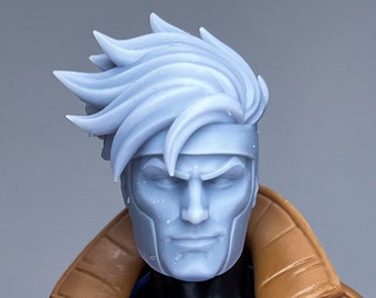 May include: A close-up of a plastic action figure head with a white, spiky hairstyle and a brown and blue jacket. The figure has a serious expression and a blue and pink chest piece.