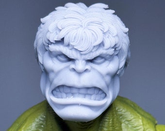 May include: A close-up of a 3D printed model of the Hulk's head. The model is painted in a light blue colour and has a detailed sculpt of the Hulk's face and hair.