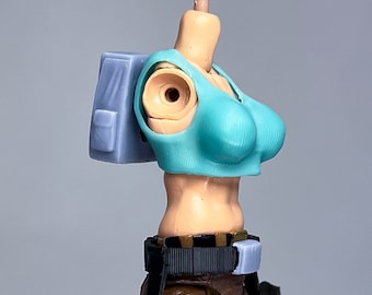 May include: A light blue crop top with a brown and black belt and two black holsters. The figure is wearing brown shorts and a gray backpack.