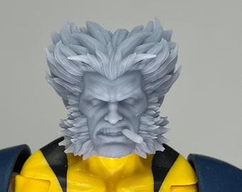 May include: A close-up of a grey plastic action figure head with a white beard and moustache. The figure has a cigarette in its mouth and a serious expression.
