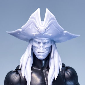 May include: A white plastic pirate captain figure with a skull face and long white hair. The figure is wearing a white plastic pirate hat with a skull and crossbones design.