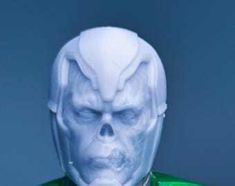 May include: A white plastic action figure head with a green and black body. The head has a skull-like design with a detailed face.