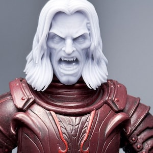 May include: A light grey, unpainted plastic action figure head with long hair and a snarling expression showing sharp fangs, attached to a dark maroon, moulded plastic torso featuring intricate, raised armour plating and decorative scrollwork details.