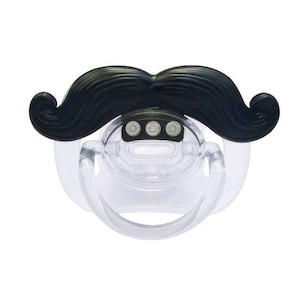 May include: A clear baby pacifier with a black mustache attached. The mustache is curved and has a classic handlebar design. The pacifier has a clear shield and a loop for attaching to a clip.