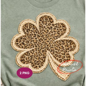 Può includere: Felpa verde salvia con un grande motivo a trifoglio. Il trifoglio presenta un motivo leopardato con un bordo beige strutturato. Il testo "Channel Prints" è visibile in basso a destra e un cerchio rosa con il testo "2 PNG" è in basso a sinistra.