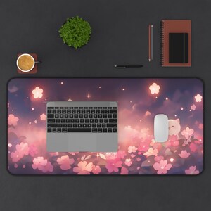 May include: A rectangular desk mat featuring a floral design with pink blossoms and a dreamy sky background. A silver keyboard, white mouse, and other office supplies are arranged on the mat.