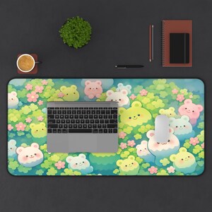 May include: A rectangular mouse pad featuring a whimsical design of cartoon bears in a garden setting. The bears are in shades of yellow, pink, and blue, surrounded by pink flowers and green foliage. A laptop, mouse, and keyboard are on the pad.