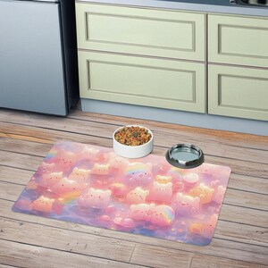 May include: A pink and blue pet feeding mat with a cartoon design of pastel-colored bears with rainbows on a cloudy background.